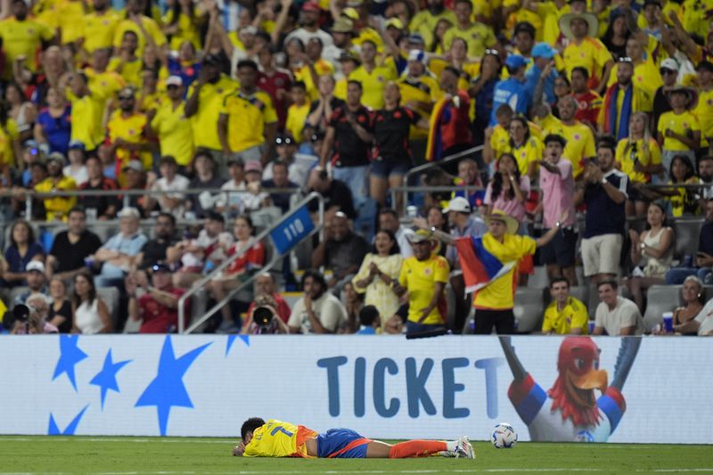 Colombia's Luis Diaz lies on the pitch during a Copa America semifinal soccer match against Uruguay in Charlotte, N.C., Wednesday, July 10, 2024. (AP Photo/Julia Nikhinson)