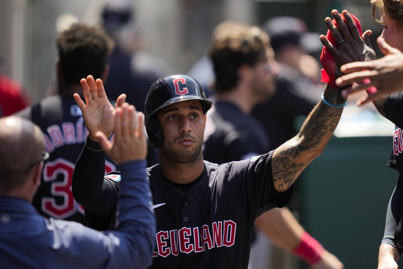 Cleveland Guardians' Brayan Rocchio celebrates in the dugout after scoring off of a walk during the sixth inning of a baseball game against the Los Angeles Angels in Anaheim, Calif., Sunday, May 26, 2024. (AP Photo/Ashley Landis)