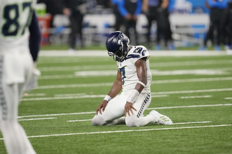 Seattle Seahawks quarterback Geno Smith kneels on the field after a play during the second half of an NFL football game against the Detroit Lions, Monday, Sept. 30, 2024, in Detroit. (AP Photo/Paul Sancya)