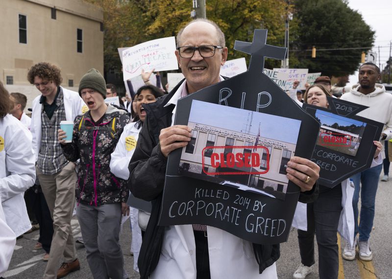 Protestors march to expand access to Medicaid in Georgia in front of Wellstar's Atlanta Medical Center which used to be an Emory Hospital before it was shut down years ago in Atlanta on Sunday, November 12, 2023. (Olivia Bowdoin for The Atlanta Journal-Constitution)