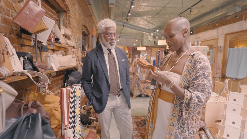 Style anthropologist Darryl Lesure observes fashion apparel with Lisa Bobb, owner of Decatur clothing boutique Squash Blossom.