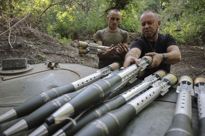 In this photo provided by Ukraine's 24th Mechanised Brigade press service, servicemen of 24th mechanised brigade prepare to fire BRM1k infantry fighting vehicle towards Russian positions near Chasiv Yar town, in Donetsk region, Ukraine, Saturday Aug. 17, 2024. (Oleg Petrasiuk/Ukrainian 24th Mechanised Brigade via AP)