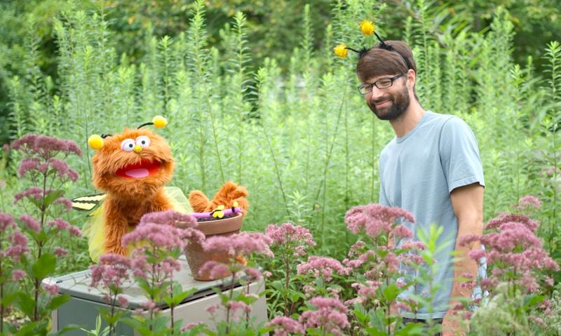In their latest video shoot, the "Nature Time" crew focused on the world of bees. Host Michael Martin is teaching the puppet Garbanzo how to be still so the bees will not fly off. 
