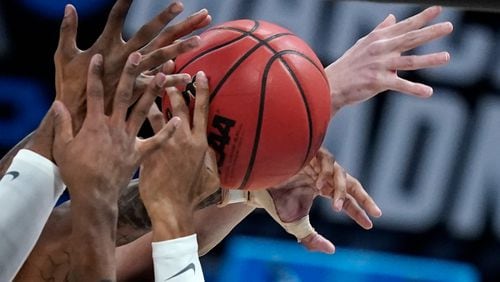 Players from West Virginia and Syracuse battle for a rebound during the first half of a second-round game in the NCAA Tournament Sunday, March 21, 2021, at Bankers Life Fieldhouse in Indianapolis. (Darron Cummings/AP)