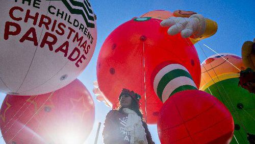 Candace Cashbaugh holds onto a guide wire for one of the giant balloons before the start of the 2015 Children's Christmas Parade in Atlanta on Saturday, December 5, 2015. Thousands gathered along Peachtree St. to watch the parade pass with marching bands, balloons, performances and more. JONATHAN PHILLIPS / SPECIAL