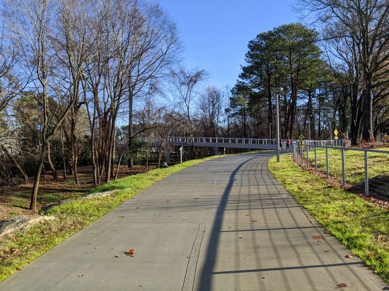 Joggers on the mile-long stretch of Peachtree Creek Greenway in Brookhaven where it crosses the stream, on Dec. 24, 2019. The trail opened Dec. 12, 2019. It could eventually extend to Atlanta’s PATH400, another growing route that could someday connect the Greenway to the Beltline and to Dunwoody and points beyond. TY TAGAMI / TY.TAGAMI@AJC.COM