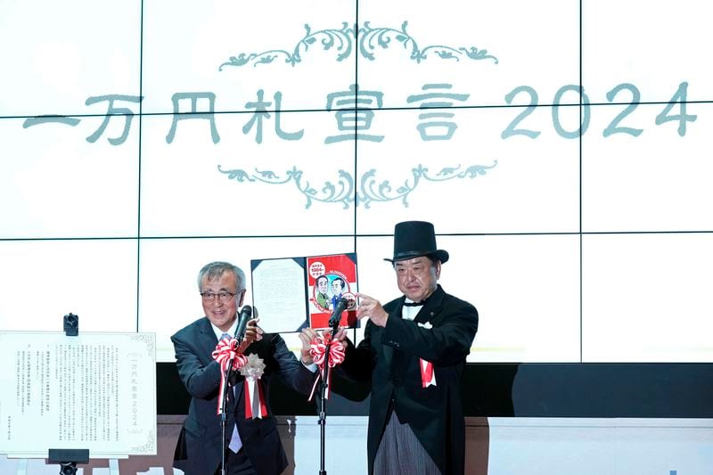 Officials attend the "10,000 Yen Bill Handover Ceremony" at Tokyo Stock Exchange Wednesday, July 3, 2024, in Tokyo. Newly designed banknotes, 10,000 yen (about US$61), 5,000 yen (about US$30) and 1,000 yen (about US$6) went into circulation Wednesday for the first time in 20 years. (AP Photo/Eugene Hoshiko)