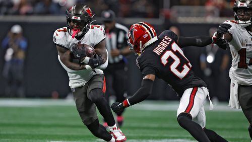 Tampa Bay Buccaneers running back Bucky Irving (7) runs against Atlanta Falcons cornerback Mike Hughes (21) during the first half of an NFL football game Thursday, Oct. 3, 2024, in Atlanta. (AP Photo/John Bazemore)