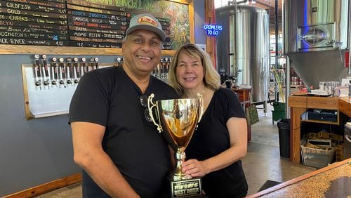 Pap and Mirva Datta in the taproom at Liquid Nation Brewing in Gainesville, Georgia. 
(Bob Townsend for the Atlanta Journal Constitution)