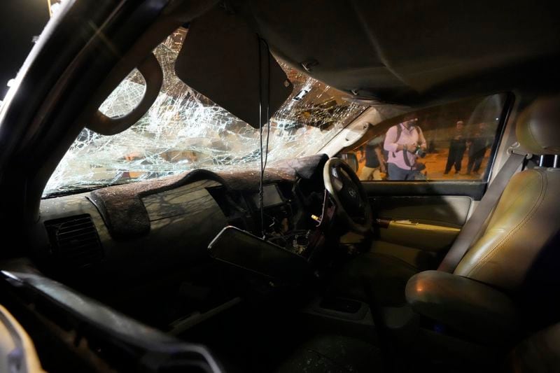 A car is seen damaged at the site of an explosion that caused injures and destroyed vehicles outside the Karachi airport, Pakistan, Monday, Oct. 7, 2024. Pakistani Baloch separatists claim deadly bomb attack that killed 2 Chinese near Karachi airport. (AP Photo/Fareed Khan)