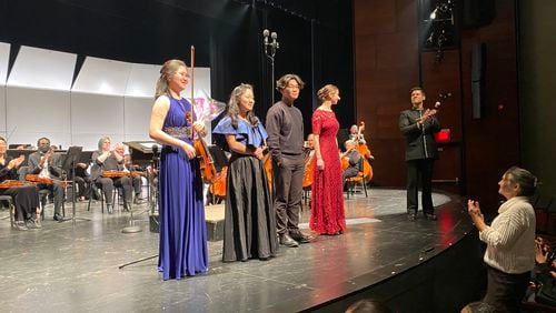 From left to right, Sunny Kim, violin; Chloe Park, flute; Jihoon Kim, cello; Emma Burnsworth, harp; and conductor Paul Bhasin.