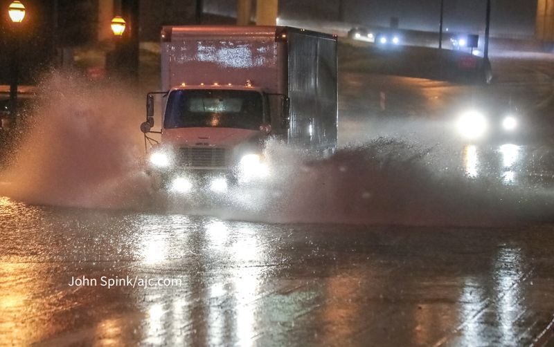 A box truck barrels through standing water along 16th Street at Techwood Drive in Midtown on Tuesday morning.
