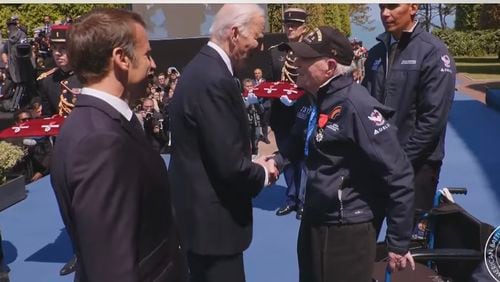 President Joe Biden meets Hilbert Margol, a 100-year-old World War II vet, at a ceremony in Normandy commemorating D-Day.  French President Emmanuel Macron is in foreground.