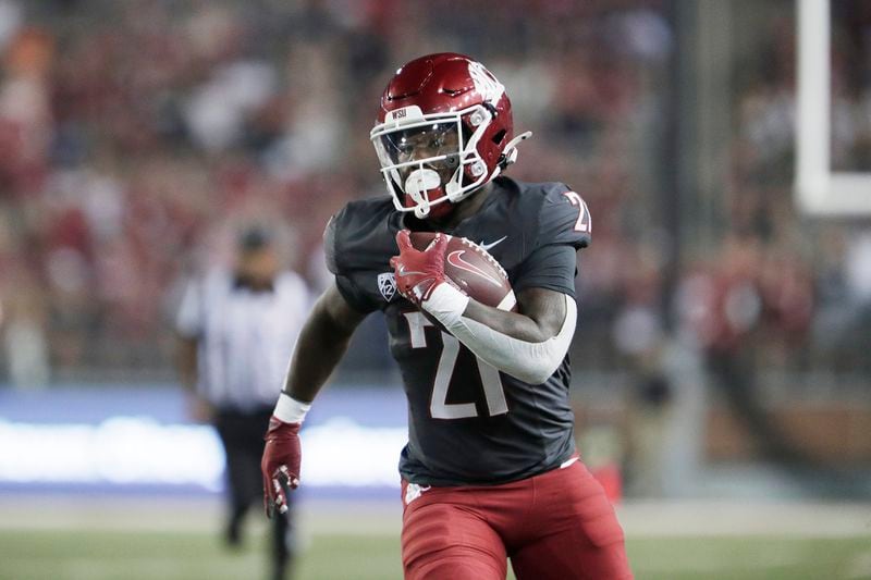 Washington State running back Wayshawn Parker (21) carries the ball during the first half of an NCAA college football game against Texas Tech, Saturday, Sept. 7, 2024, in Pullman, Wash. (AP Photo/Young Kwak)