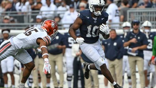 Penn State running back Nicholas Singleton (10) runs away from Bowling Green linebacker Avi McGary (15) during the second quarter of an NCAA college football game against Penn State, Saturday, Sept. 7, 2024, in State College, Pa. (AP Photo/Barry Reeger)