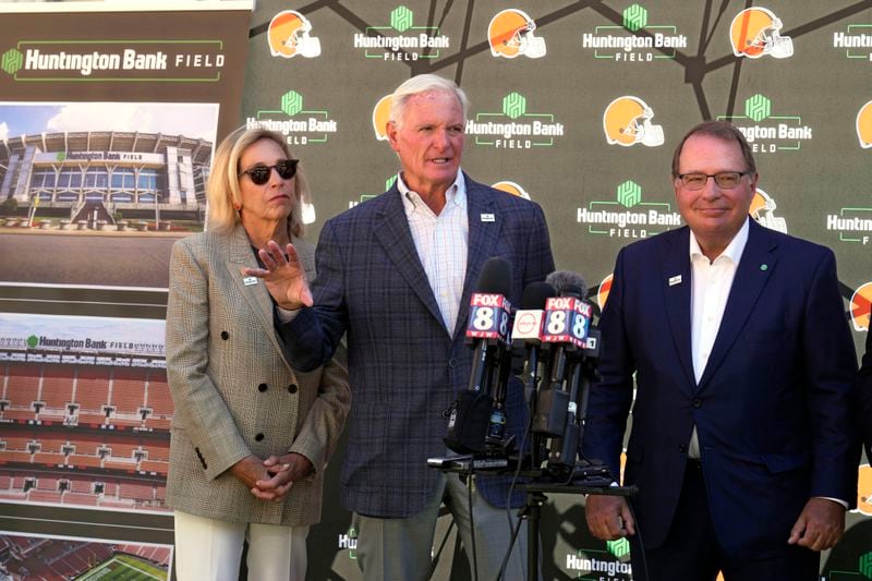 Cleveland Browns owners Dee Haslam, left, Jimmy Haslam, center, and Steve Steinour, right, Huntington Bank chairman, president and chief executive officer, speak during an NFL football news conference announcing that Cleveland Browns Stadium will now be called Huntington Bank Field, Tuesday, Sept. 3, 2024, in Cleveland. (AP Photo/Sue Ogrocki)