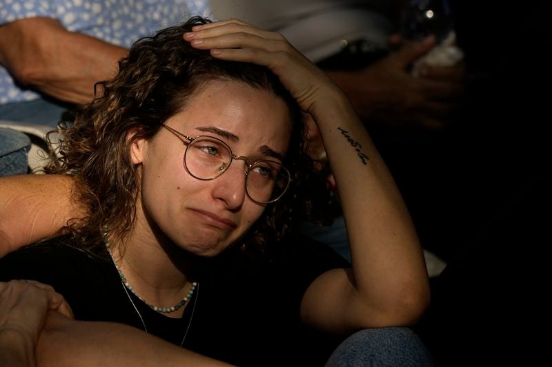 Ophir mourns during the funeral of her grandfather Yoram Metzger at a cemetery of the kibbutz Nir Oz, southern Israel, Thursday, Aug. 22, 2024. Metzger's body was one the six bodies of hostages, taken in Hamas' Oct. 7 attack, recovered by Israel's military during an operation in the Gaza Strip. (AP Photo/Tsafrir Abayov)