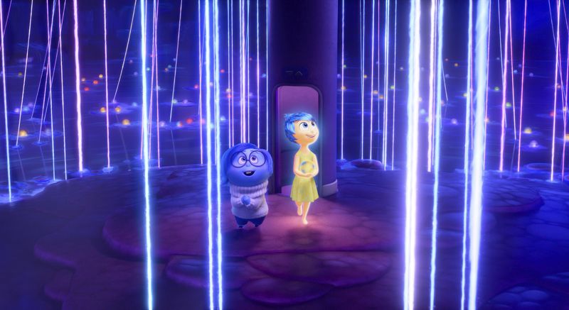 This image released by Disney/Pixar shows, from left, Sadness, voiced by Phyllis Smith, left, and Joy, voiced by Amy Poehler, in a scene from "Inside Out 2." (Disney/Pixar via AP)