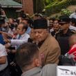 National Conference party leader Farooq Abdullah, center, wearing black cap, is surrounded by journalists as party celebrate early leads in the election for a local government in Indian controlled Kashmir, Srinagar, Tuesday, Oct. 8, 2024. (AP Photo/Dar Yasin)