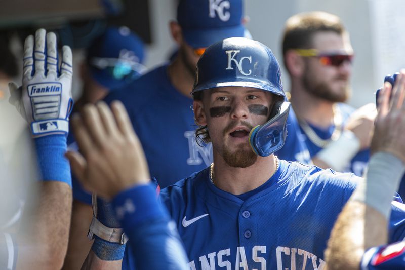 Kansas City Royals' Bobby Witt Jr. is congratulated by his teammates after hitting a solo home run off Cleveland Guardians relief pitcher Hunter Gaddis inning of the first game of a baseball doubleheader in Cleveland, Monday, Aug. 26, 2024. (AP Photo/Phil Long)