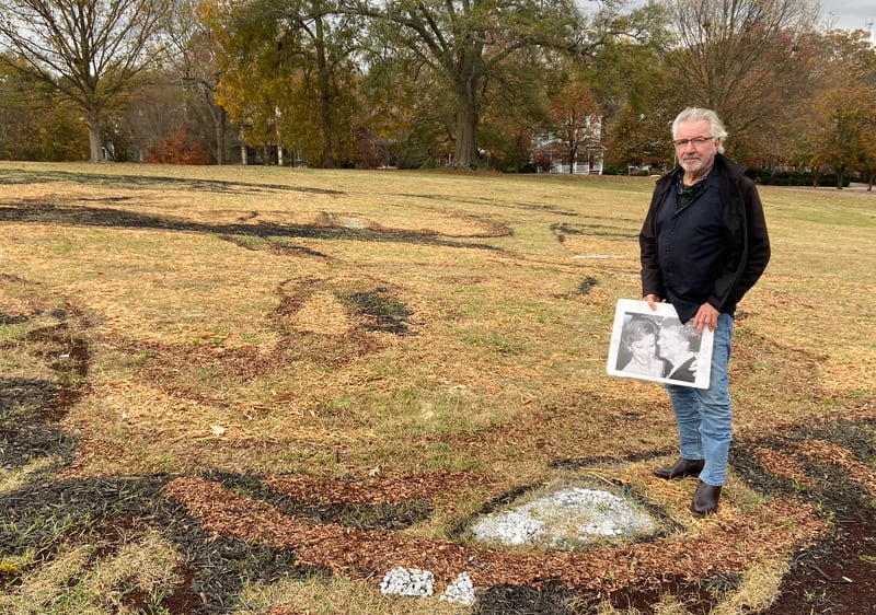 Artist Stan Herd posed with a picture of Jimmy and Rosalynn Carter on top of an Earthworks portrait he made in Freedom Park on Nov. 22, 2023.