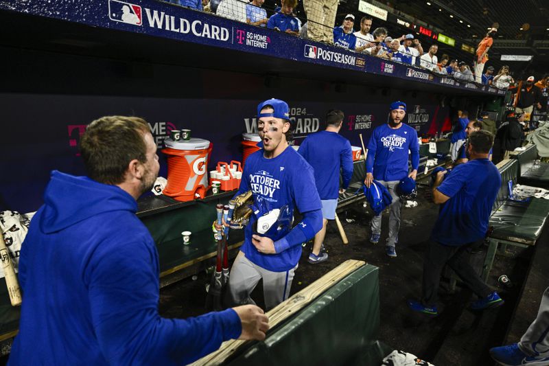 Kansas City Royals shortstop Bobby Witt Jr., center, reacts with a staff member after defeating the Baltimore Orioles 2-1 in Game 2 of an AL Wild Card Series baseball game, Wednesday, Oct. 2, 2024 in Baltimore. (AP Photo/Nick Wass)