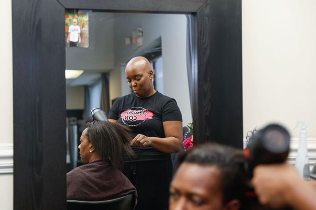 Felicia Flores, founder of Baldie Con dries her client Erica Bledsoe’s hair at her salon in Buckhead on Wednesday, Sept. 25, 2024. Flores launched Baldie Con a few years ago for women, children and men with hair loss issues. (Natrice Miller/ AJC)