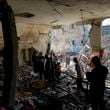 Palestinians examine the damage following an Israeli airstrike in the West Bank city of Tulkarem, which Palestinian health officials say killed 18 people and the Israeli military says took out a Hamas leader, on Friday, Oct. 4, 2024. (AP Photo/Nasser Nasser)