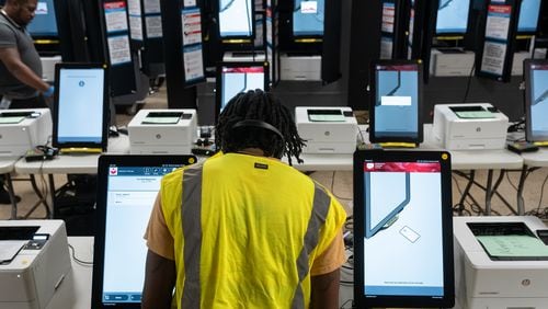 Dekalb County Elections officals conduct logic and accuracy testing of Dominion voting machines in September. (Ben Hendren for The Atlanta Journal-Constitution)