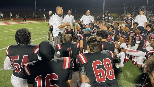 Hillgrove coach Justin DeShon talks with his team after the Hawks' 24-21 victory over Marietta on Sept. 6, 2024, in Powder Springs.