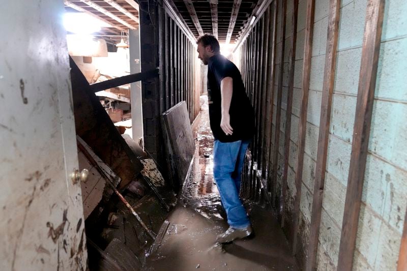 Contractor Joshua Taylor stands in the basement of a funeral home that was flooded in the aftermath of Hurricane Helene while working to clean up the building Saturday, Oct. 5, 2024, in Newport, Tenn. (AP Photo/Jeff Roberson)