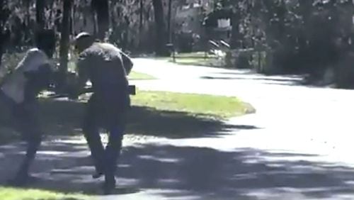 In this image from video posted on Twitter on May 5, 2020, Ahmaud Arbery, left, struggles with Travis McMichael over a shotgun on a street in a neighborhood outside Brunswick, Georgia, on Feb. 23, 2020. Arbery, who was jogging when he was confronted by McMichael and his father and shot multiple times. The 25-year-old died at the scene.