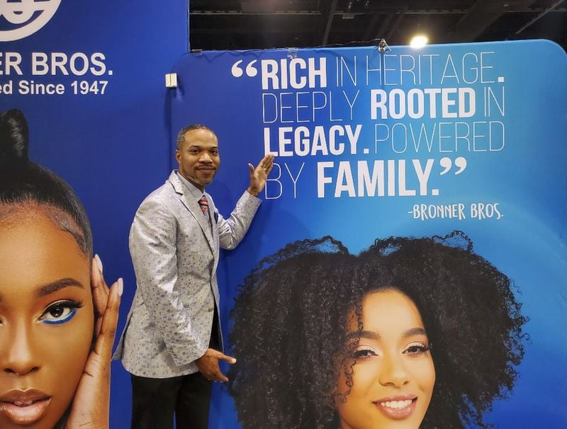Company president James Bronner stands near signage at the 2020 Bronner Bros. International Hair Show. Photo courtesy of Bronner Bros. Inc. 