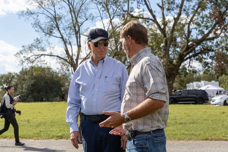 President Joe Biden greets farmer Buck Paulk (right) at his pecan farm in Ray City on Thursday and surveyed damage from Hurricane Helene.