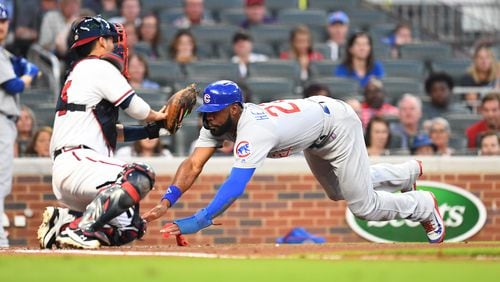 The Cubs’ Jason Heyward  scores a run  in the second inning Thursday night at SunTrust Park.