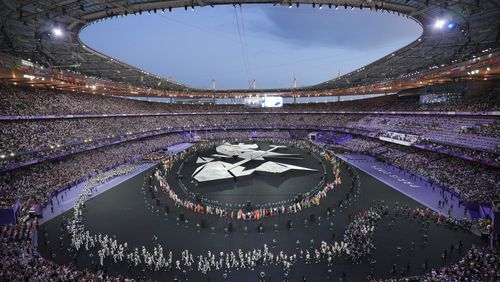 Flag bearers march during the 2024 Summer Olympics closing ceremony at the Stade de France, Sunday, Aug. 11, 2024, in Saint-Denis, France. (AP Photo/Kin Cheung)