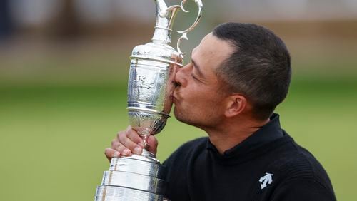 Xander Schauffele of the United States kisses the Claret Jug trophy after winning the British Open Golf Championships at Royal Troon golf club in Troon, Scotland, Sunday, July 21, 2024. (AP Photo/Peter Morrison)