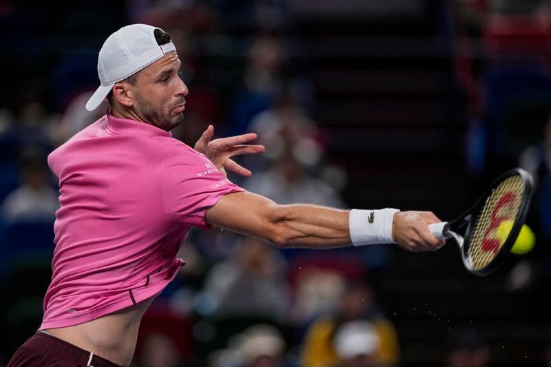 Grigor Dimitrov of Bulgaria returns a shot to Zizou Bergs of Belgium during the men's singles second round match in the Shanghai Masters tennis tournament at Qizhong Forest Sports City Tennis Center in Shanghai, China, Monday, Oct. 7, 2024. (AP Photo/Andy Wong)