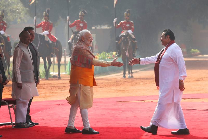 FILE - Indian Prime Minister Narender Modi, center left, greets his then Sri Lankan counterpart Mahinda Rajapaksa, during a ceremonial reception at the Indian presidential palace, in New Delhi, India, Feb. 8, 2020. (AP Photo/Manish Swarup, File)