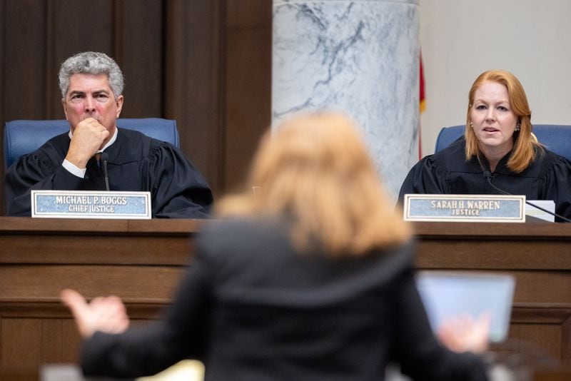 Georgia Supreme Court Chief Justice Michael Boggs and Justice Sarah Warren listen to oral arguments at a hearing in Atlanta on Tuesday.