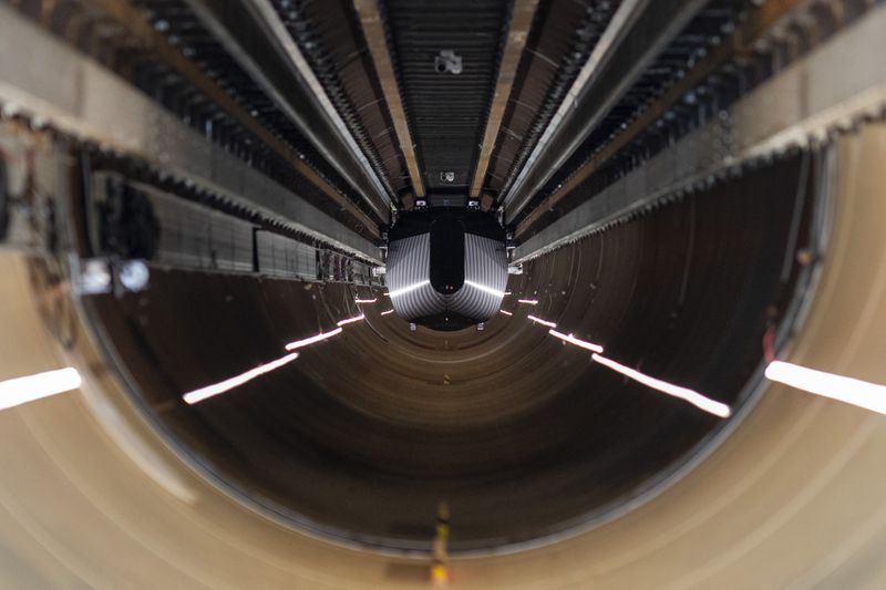 A test vehicle levitated by magnetic fields zips through a depressurized tube in a testing ground for a high-speed transit system during a press tour of a European test center for hyperloop transportation technology in Veendam, northern Netherlands, Friday, Sept. 6, 2024. (AP Photo/Peter Dejong)