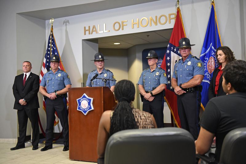 Col. Mike Hagar, center, at podium, answers questions from the media during a news conference regarding Friday's deadly shooting at an Arkansas grocery store, in Fordyce, Ark., Sunday, June 23, 2024. (Staci Vandagriff/Arkansas Democrat-Gazette via AP)