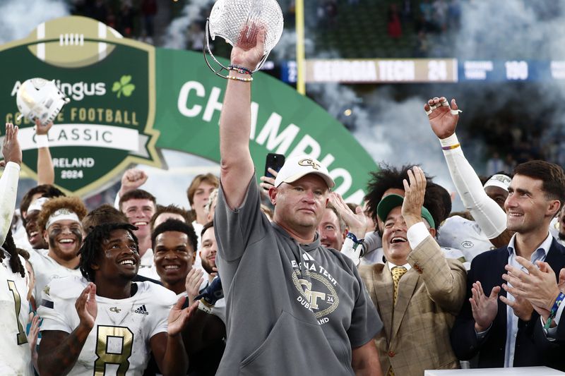 Georgia's head coach Brent Key celebrates with his team after the NCAA college football game between Georgia Tech and Florida State at the Aviva stadium in Dublin, Saturday, Aug. 24, 2024. (AP Photo/Peter Morrison)