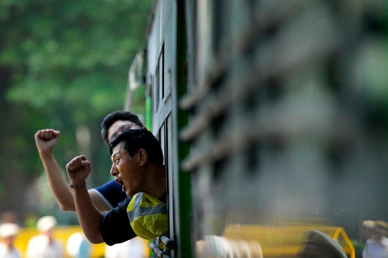 Exile Tibetans who are detained shout slogans against the human rights situation in Tibet from a police vehicle during a protest to coincide China marking its 75th year of Communist Party rule, outside Chinese embassy, in New Delhi, India, Tuesday, Oct. 1, 2024. (AP Photo/Manish Swarup)