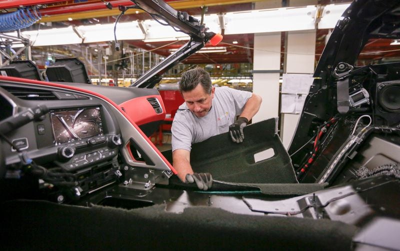 A General Motors Bowling Green Corvette Assembly operator installs the carpet while assembling a 2014 Chevrolet Corvette Stingray Thursday, June 27, 2013 at the plant in Bowling Green, Kentucky. (Photo by AJ Mast for Chevrolet)