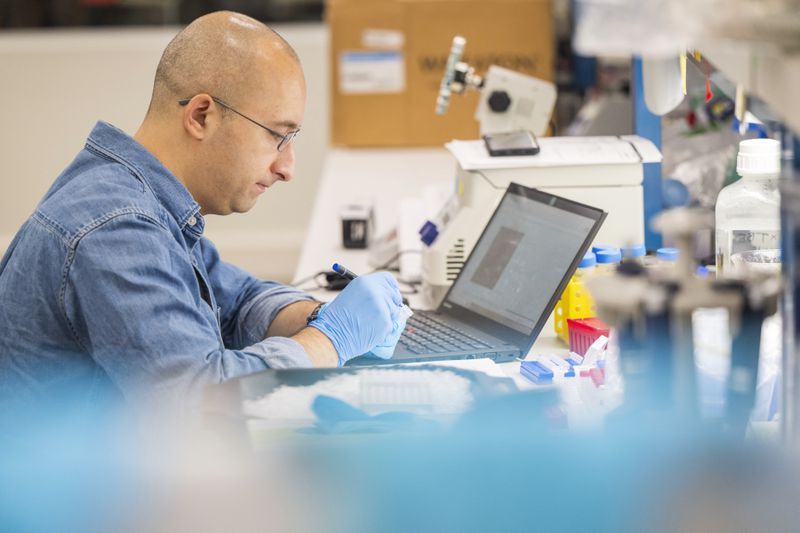 A lab technician prepares DNA samples for analysis at Complete Genomics in San Jose, Calif., Monday, July 22, 2024. (AP Photo/Nic Coury)