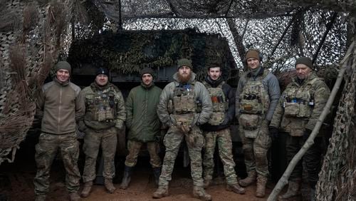FILE - Soldiers of 12th Special Forces Brigade Azov of the National Guard pose for a photo at the 155mm self-propelled gun M109 Paladin at the front line, near Kreminna, Luhansk region, Ukraine, Sunday, Jan. 28, 2024. The U.S. has removed restrictions on the transfer of American weapons and training to a high-profile Ukrainian military unit with a checkered past, the State Department said on Tuesday, June 11, 2024. (AP Photo/Efrem Lukatsky, File)