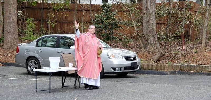 Father Brian Sheridan of St. Thomas the Apostle in Smyrna, shown offering drive-by blessings in April.