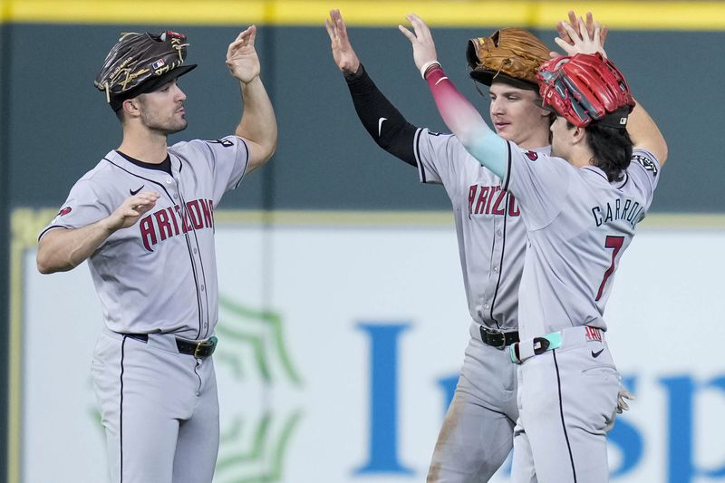 Arizona Diamondbacks' Randal Grichuk, left, Jake McCarthy, center, and Corbin Carroll celebrate the team's win over the Houston Astros in a baseball game Sunday, Sept. 8, 2024, in Houston. (AP Photo/Eric Christian Smith)