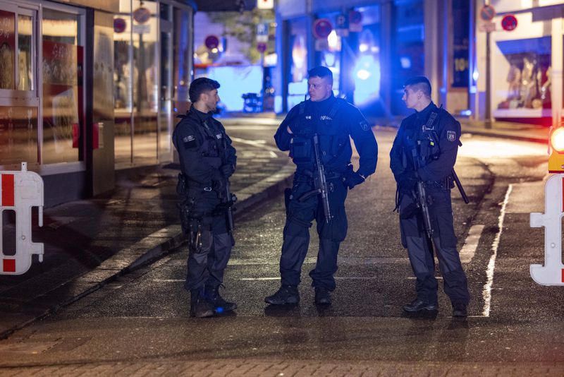 Police and deployed near the scene where people were killed and injured in an attack at a festival in Solingen, western Germany, the German dpa news agency reported, Friday, Aug. 23, 2024. (Gianni Gattus/dpa via AP)